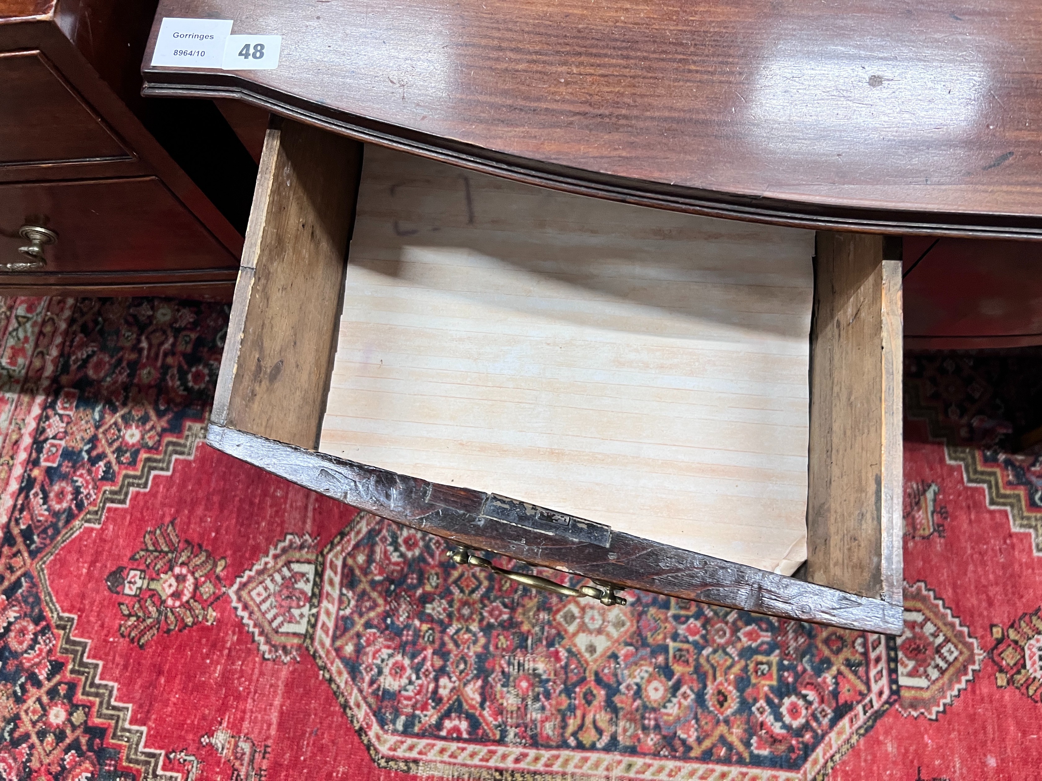 A George III mahogany bowfront two drawer side table, width 86cm, depth 54cm, height 74cm *Please note the sale commences at 9am.
